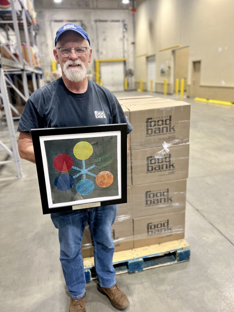 Bruce Bartel, Director of Operations, with the Living Our Values Award at the Kansas Food Bank