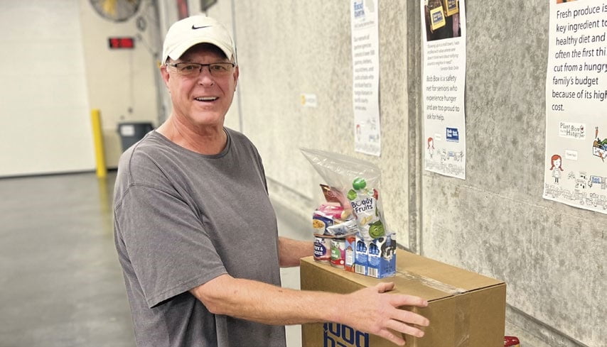 Kevin helps prepare Food 4 Kids packets on a recent volunteer shift.